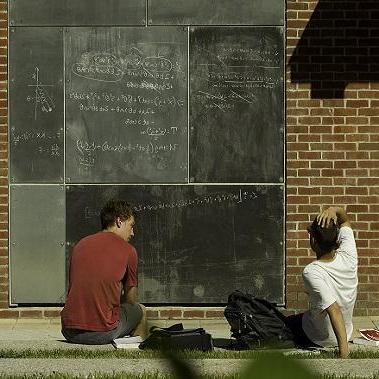 students sitting outside studying